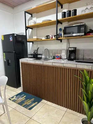 a kitchen with a counter and a black refrigerator at El refugio in Nosara