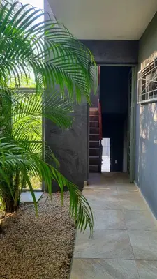 a house with a palm tree in front of a door at Casa Celeste in Playa Pelada