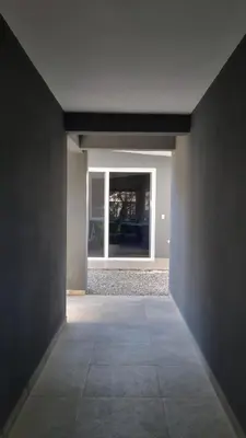 an empty hallway with a window in a house at Casa Celeste in Playa Pelada
