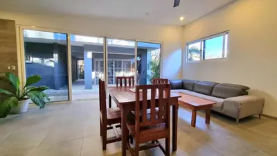 a living room with a table and a couch at Casa Celeste in Playa Pelada