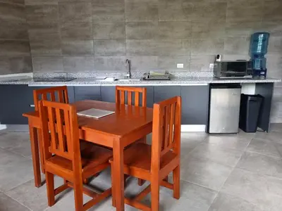 a kitchen with a wooden table and two chairs at Casa Celeste in Playa Pelada