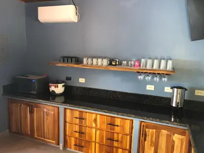a kitchen with wooden cabinets and a black counter top at Club Fred Aparthotel in Punta Mala