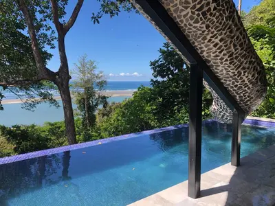 a swimming pool with a view of the ocean at Club Fred Aparthotel in Punta Mala