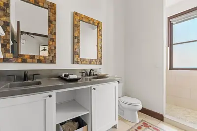 a bathroom with a sink and two mirrors at LC Casa Olas in Playa Danta