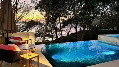 a swimming pool with a table and chairs next to it at LC Casa Olas in Playa Danta
