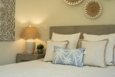 a bedroom with a bed with white and blue pillows at Luxury 3BR Gated Villa - Private Pool in Tamarindo in Tamarindo