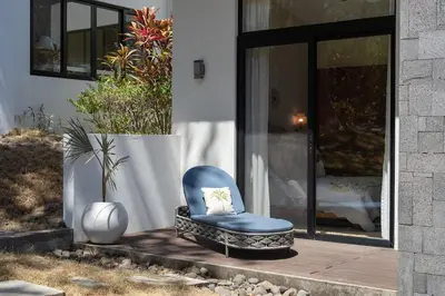 a blue chair sitting outside of a house at Luxury 3BR Gated Villa - Private Pool in Tamarindo in Tamarindo