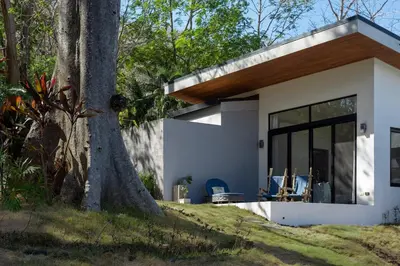 a small white house with a tree at Luxury 3BR Gated Villa - Private Pool in Tamarindo in Tamarindo