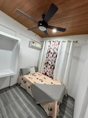 a bedroom with a bed and a ceiling fan at Harol reyes in Liberia