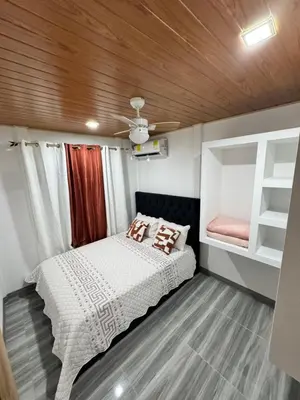 a small bedroom with a bed and a ceiling at Harol reyes in Liberia