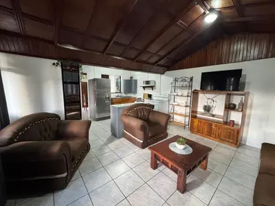 a living room with two couches and a coffee table at Casa Aurora, Nuevo Arenal in Arenal