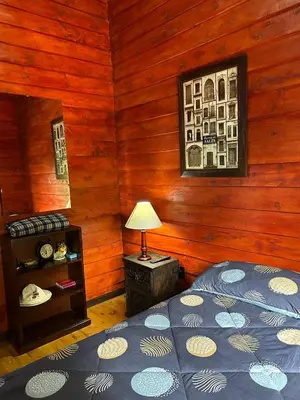 a bedroom with a bed and a lamp in it at Cabaña de Montaña El Jardin in Jardín