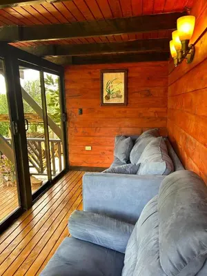 a room with two beds in a wooden wall at Cabaña de Montaña El Jardin in Jardín