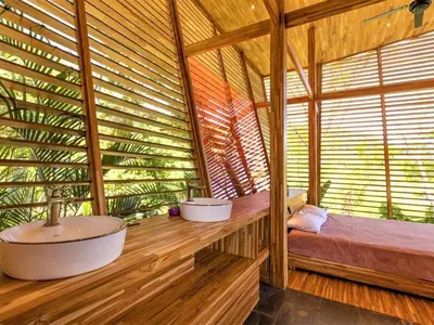 a large wooden room with a tub and a large window at The Zen, Award-Winning Sanctuary in Uvita in Uvita
