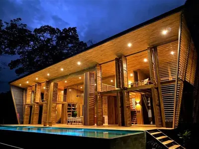 a house with a swimming pool in front of it at The Zen, Award-Winning Sanctuary in Uvita in Uvita