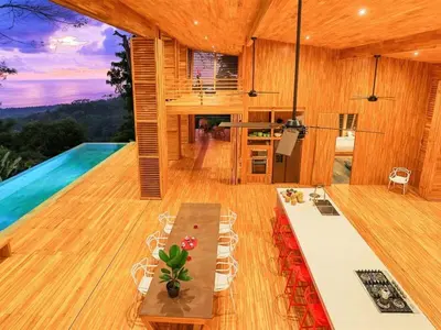 a living room with a table and a pool at The Zen, Award-Winning Sanctuary in Uvita in Uvita