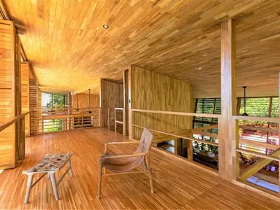 a room with a chair and a table and wooden ceilings at The Zen, Award-Winning Sanctuary in Uvita in Uvita