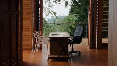 a desk with a chair and a lamp on a balcony at The Zen, Award-Winning Sanctuary in Uvita in Uvita