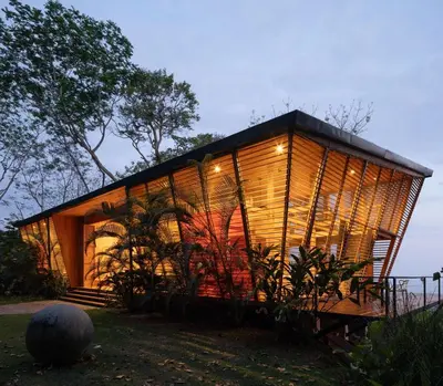 a house with a lot of windows on a field at The Zen, Award-Winning Sanctuary in Uvita in Uvita