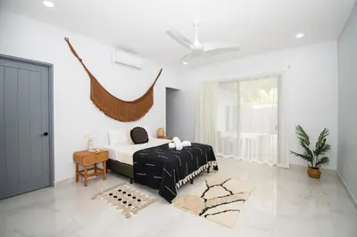 a bedroom with a black and white bed and a window at New! 3 Bedroom Villa in Uvita, Large Pool! in Uvita