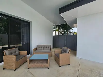 a patio with wicker chairs and a coffee table at New! 3 Bedroom Villa in Uvita, Large Pool! in Uvita