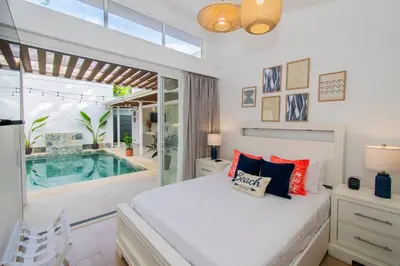 a bedroom with a bed and a swimming pool at NEW! Villa, 3bdrs with AC, Pool, close to Marino Ballena in Uvita