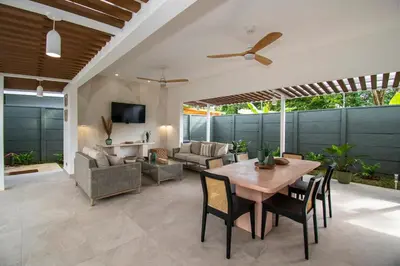 a living room with a wooden table and chairs at NEW! Villa, 3bdrs with AC, Pool, close to Marino Ballena in Uvita