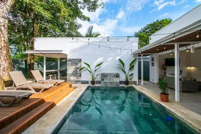 a swimming pool with a patio and a house at NEW! Villa, 3bdrs with AC, Pool, close to Marino Ballena in Uvita