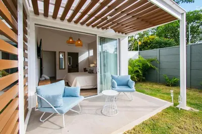 a patio with two chairs and a table and a bed at NEW! Villa, 3bdrs with AC, Pool, close to Marino Ballena in Uvita