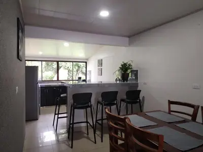 a kitchen and dining room with a table and chairs at Casa Mi Bello Arenal, Rio el Salto and Fortuna in Fortuna