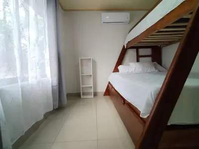 a bedroom with a bunk bed and a window at Casa Mi Bello Arenal, Rio el Salto and Fortuna in Fortuna