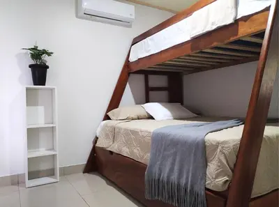 a bedroom with a bunk bed in a room at Casa Mi Bello Arenal, Rio el Salto and Fortuna in Fortuna