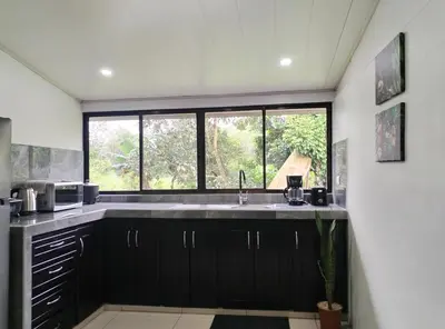 a kitchen with a large sink and a window at Casa Mi Bello Arenal, Rio el Salto and Fortuna in Fortuna