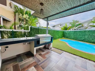 a bathroom with a sink and a swimming pool at Elegant large house in Punta Leona Bamboo in Punta Leona