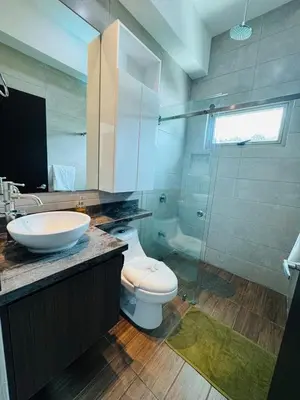 a bathroom with a toilet and a sink and a shower at Elegant large house in Punta Leona Bamboo in Punta Leona