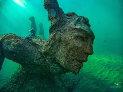 a statue of a woman in the water at Elegant large house in Punta Leona Bamboo in Punta Leona