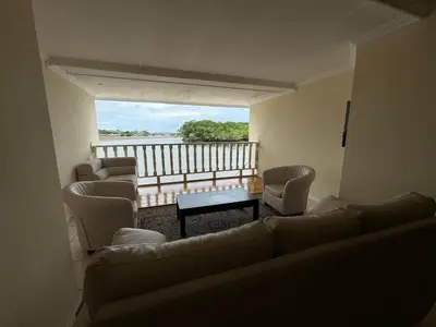 a living room with a couch and chairs and a balcony at Hotel y Restaurante Costa del Sol in Mata de Limón