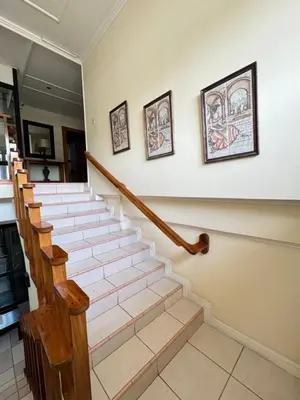 a staircase in a house with two pictures on the wall at Hotel y Restaurante Costa del Sol in Mata de Limón