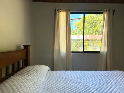 a bedroom with a bed and a window at Casa Fabis en Playa Junquillal, Playa a 600m in Santa Cruz