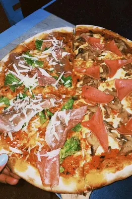 a pizza sitting on top of a table at Casa Fabis en Playa Junquillal, Playa a 600m in Santa Cruz