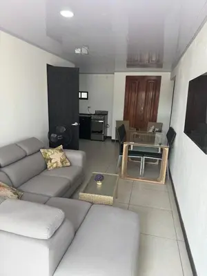 a living room with a couch and a table at Floral Departments in Comunidad