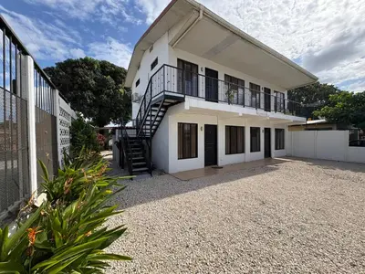 a white building with a staircase in front of it at Floral Departments in Comunidad