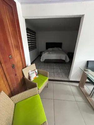 a room with a bed and a couch and a chair at Floral Departments in Comunidad