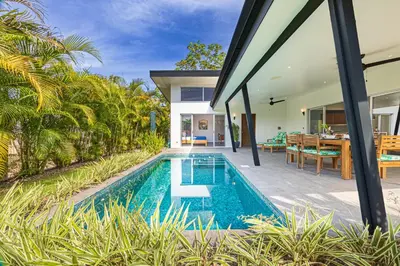 an external view of a villa with a swimming pool at Villa Dos Vistas in Uvita