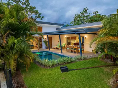 a house with a swimming pool in a yard at Villa Dos Vistas in Uvita