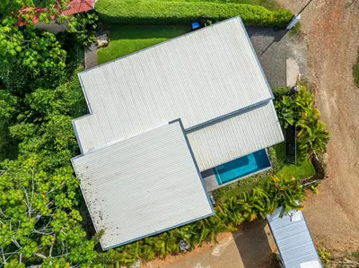 an overhead view of a white house with a pool at Villa Dos Vistas in Uvita