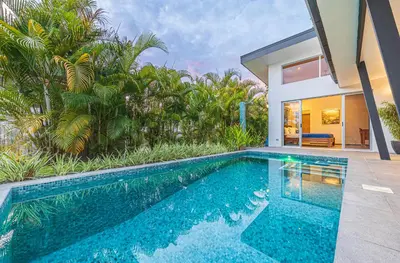 a swimming pool in front of a house at Villa Dos Vistas in Uvita