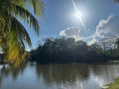 a view of a river with the sun in the sky at Los Delfines 560 in Tambor