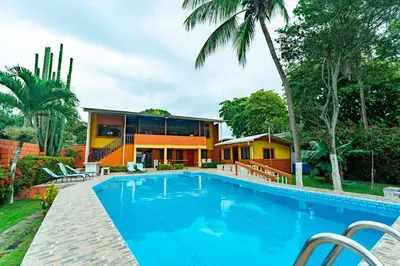 an exterior view of a house with a swimming pool at Casa Rector - Beach House Rental in El Roble