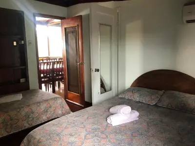 a bedroom with two beds with towels on top of it at Casa Rector - Beach House Rental in El Roble
